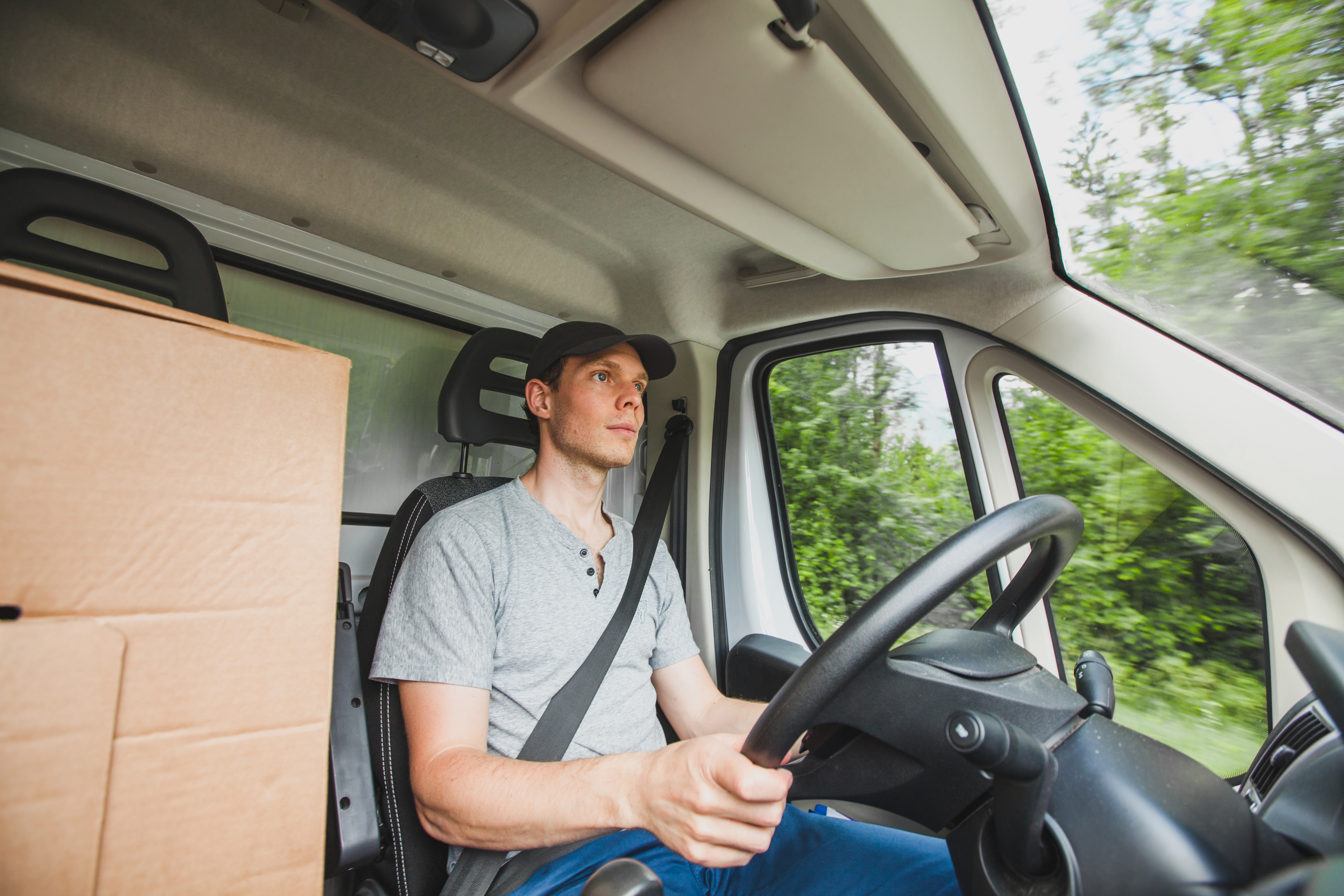 man driving delivery truck car vehicle, service of delivering package cargo, transportation occupation job