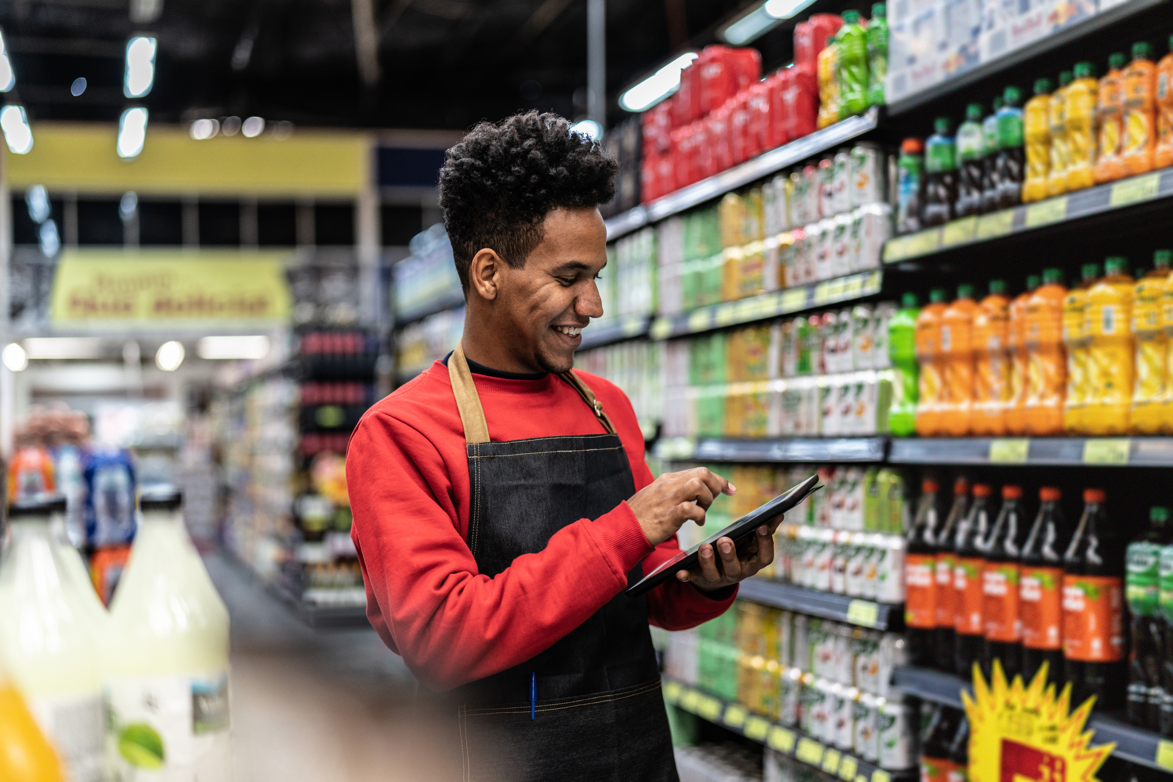 Grocery store employee checking prices