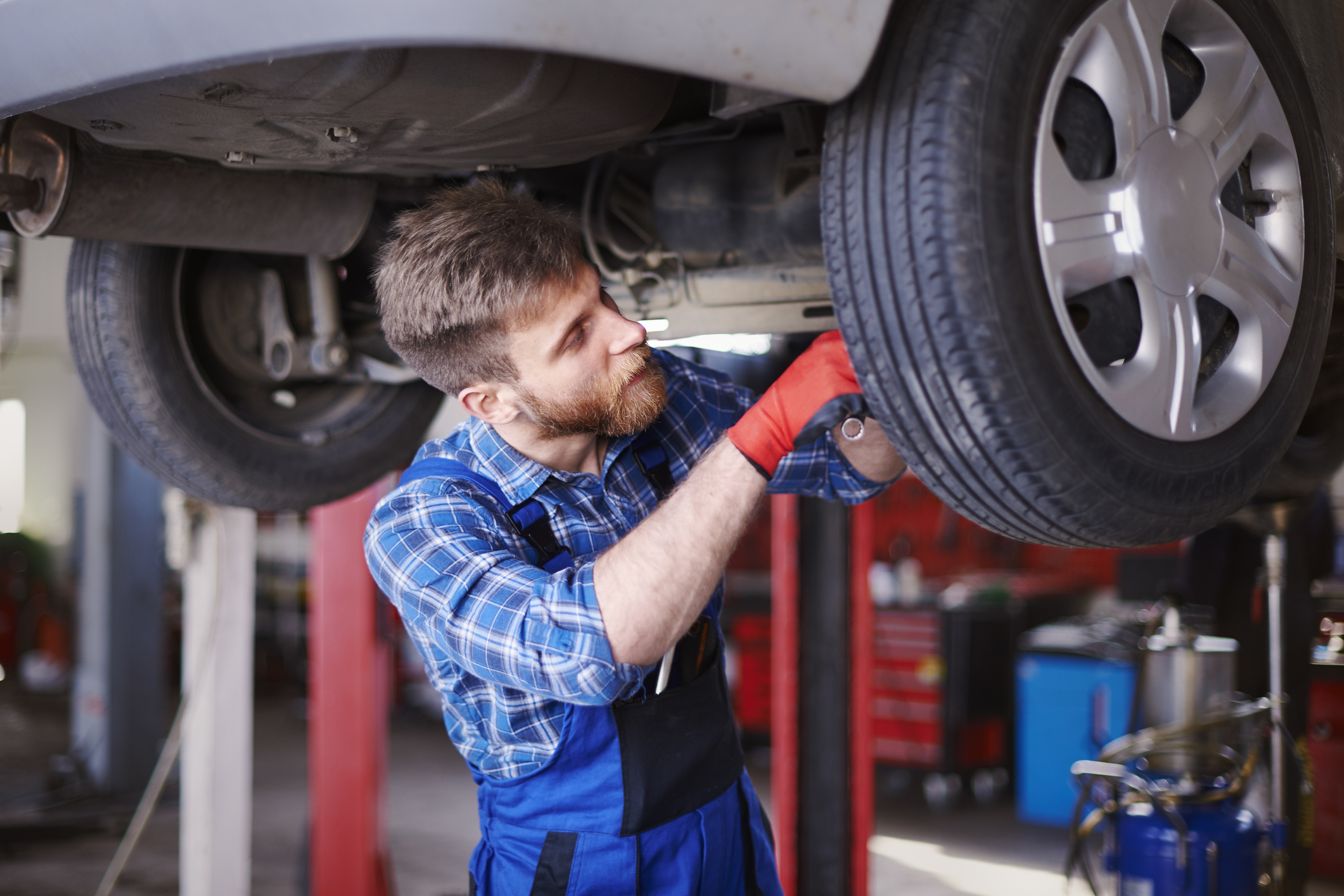 Mechanic working on a car on a lift